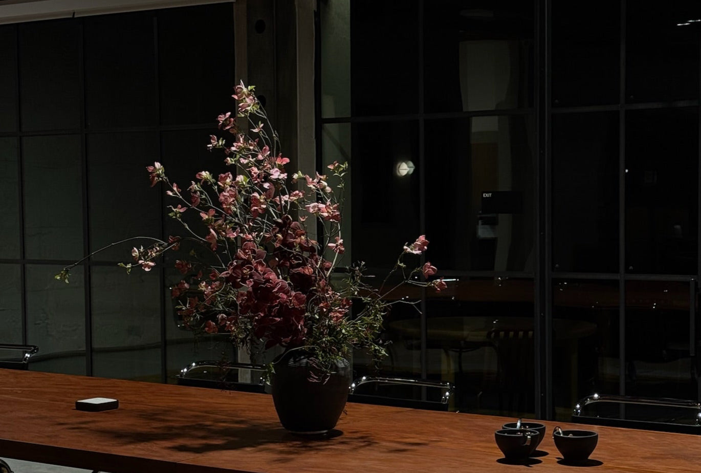 Bouquet of flowers in a vase on a wooden table with a dark background
